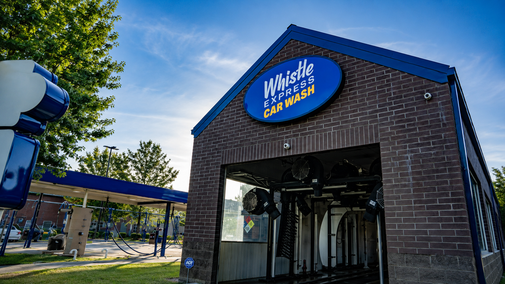 Whistle Express Car Wash exterior with blue trim and open wash bay.